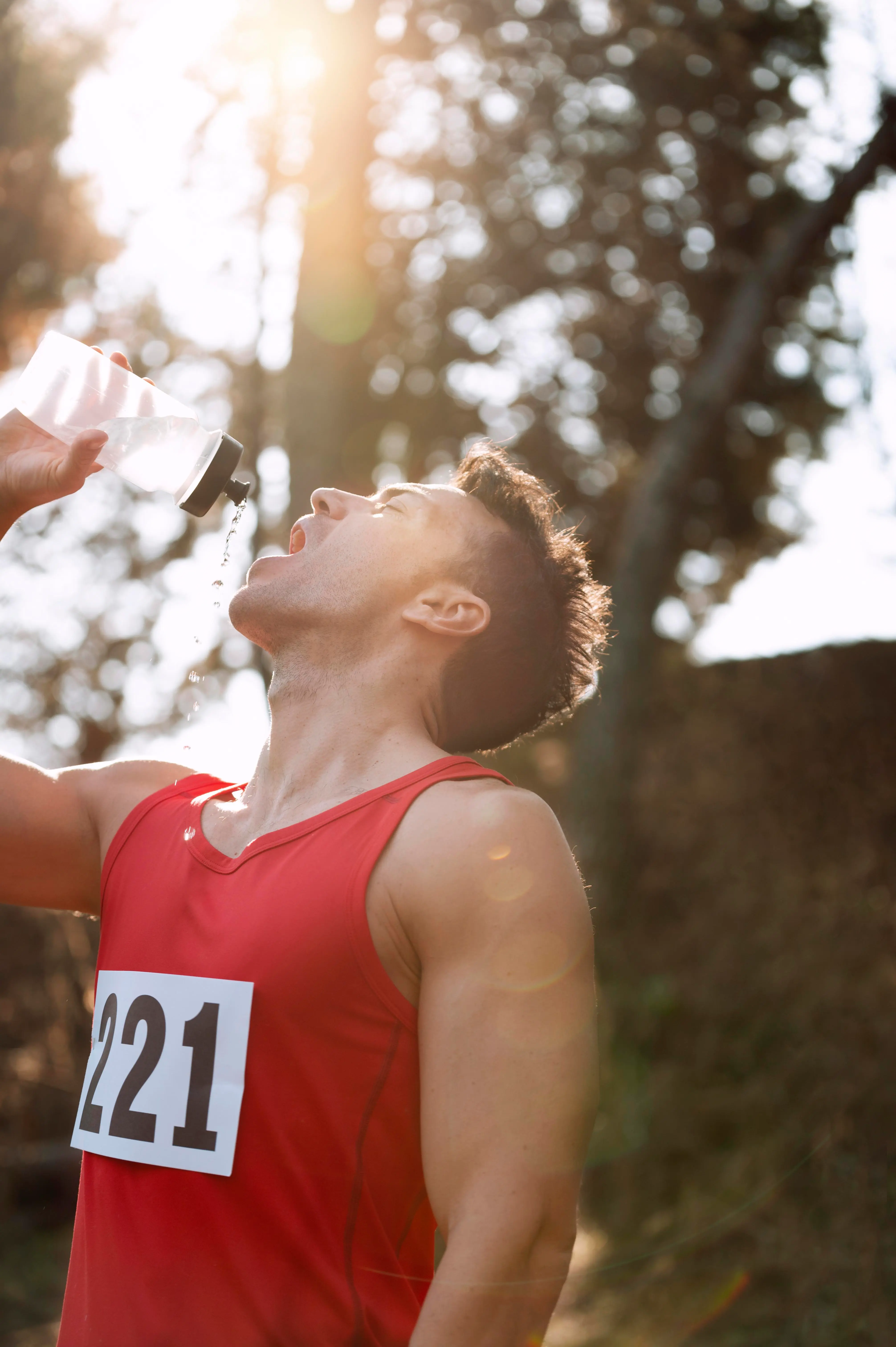 A runner cools off with water on the course